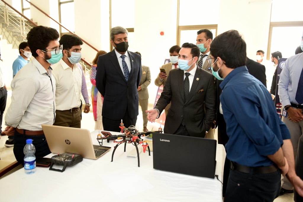 Figure 3: Mr. Sardar Yasir Illyas Khan accompanied by AVM Dr. Rizwan Riaz to a stall on Drone-Technology 