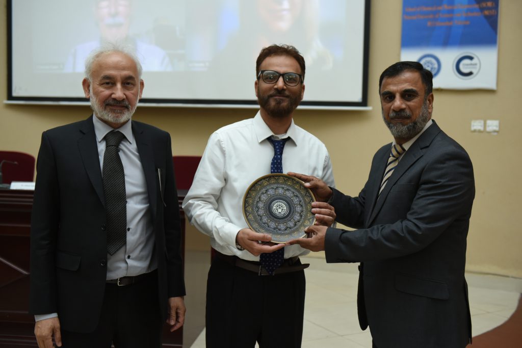 Figure 1. Director Research, Dr Hamood Ur Rahman presenting NUST shield to Dr. Adnan Syed from Cranfield University