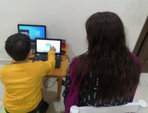 Figure 3: Child performing web-based intervention along with therapist
