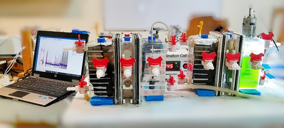 Figure 3: Experimental Setup of a Photosynthetic Microbial Desalination Cell (PMDC) displaying a laboratory setup, connected to a data acquisition system for monitoring electrochemical processes